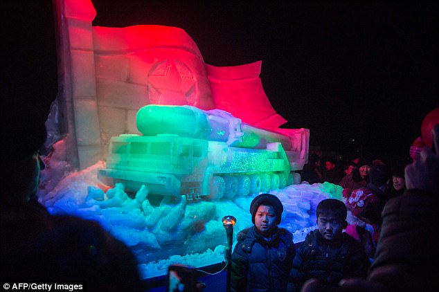 http://reho.st/i.dailymail.co.uk/i/pix/2018/01/01/01/47AA107300000578-5225201-Children_pose_for_a_photo_before_an_ice_sculpture_of_an_ICBM_and-a-17_1514771569050.jpg